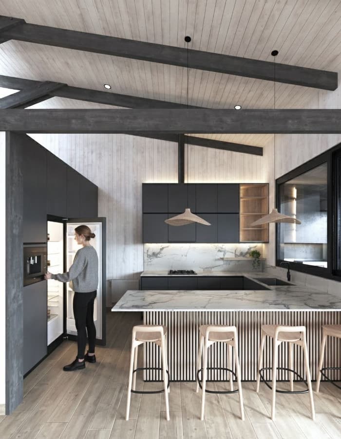 Cocina con isla de mármol y cerchas a la vista
